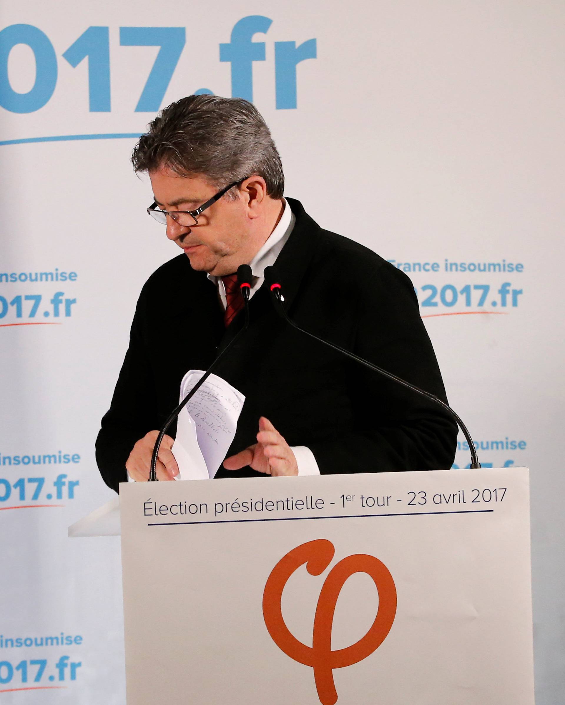 Jean-Luc Melenchon, candidate of the French far-left Parti de Gauche and candidate for the French 2017 presidential election, leaves after delivering a speech in a bar in Paris after early results in the first round of 2017 French presidential election