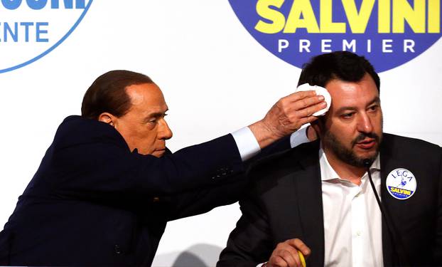 Forza Italia leader Silvio Berlusconi wipes the sweat off Northern League leader Matteo Salvini during a meeting in Rome