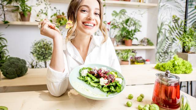 Portrait,Of,A,Young,Woman,Eating,Healthy,Food,Sitting,In