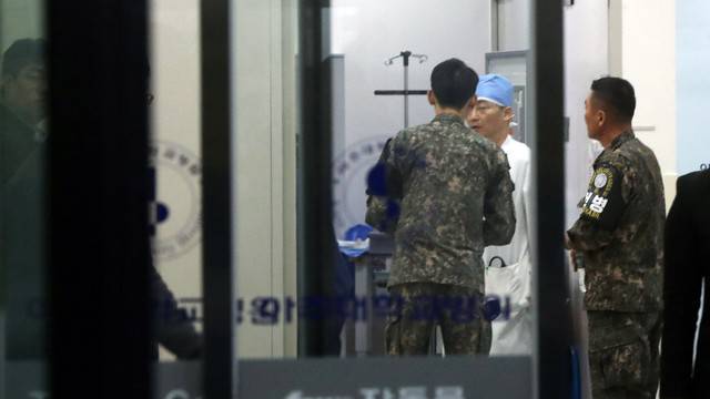 A South Korean soldier talks with a surgeon at a hospital where a North Korean soldier who defected to the South after being shot and wounded by the North Korean military is hospitalized, in Suwon