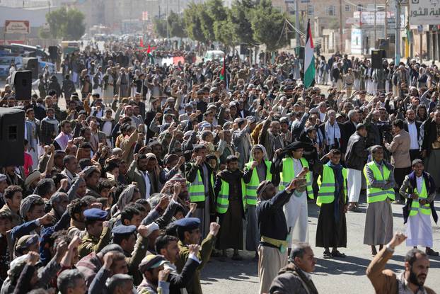 Houthi supporters shout slogans as they attend a ceremony at the end of the training of newly recruited Houthi fighters in Sanaa