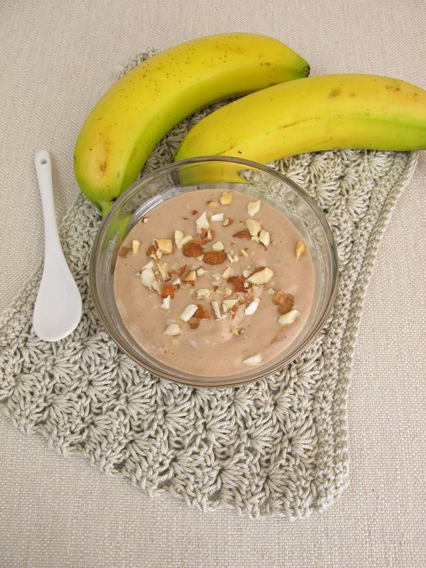 Homemade chocolate ice cream with frozen bananas, cocoa and almonds