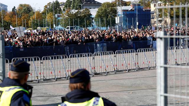 Police officers stand guard near counter-demonstrators prior to the Nordic Resistance Movement's (NMR) march in central Gothenburg, Sweden