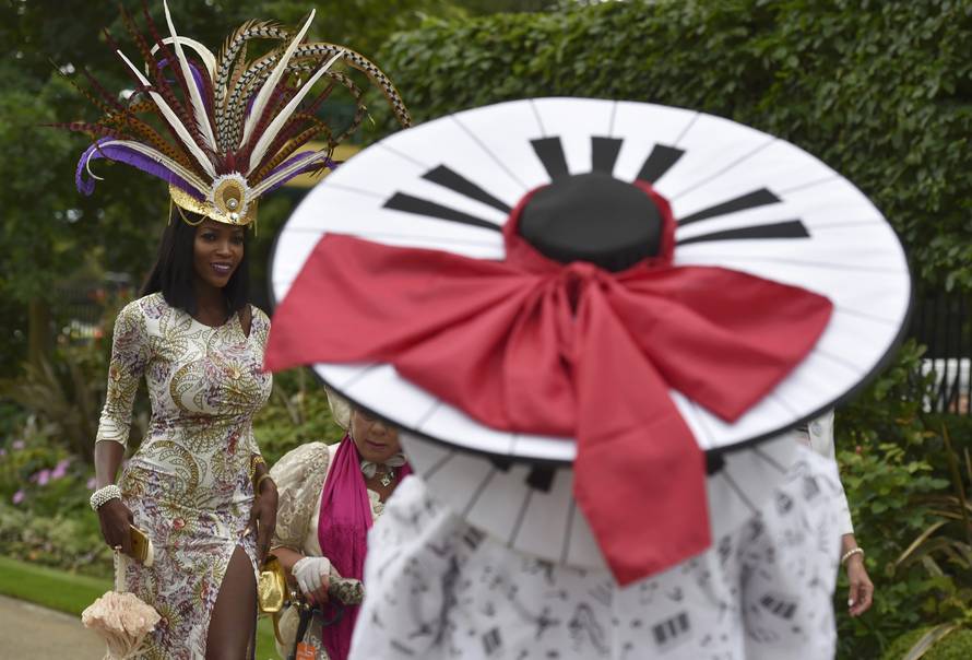 Britain Horse Racing Ladies Day Racegoers wear hats