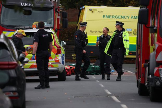 Police officers work at the scene following an incident outside a synagogue, in Manchester