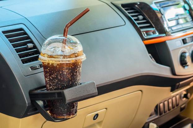 Bottle with cola in a car interior