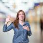 Pretty young business woman making an oath over blur background