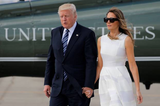 Trump and first lady hold hands as they arrive to board Air Force One for travel to Rome from Ben Gurion International Airport in Tel Aviv
