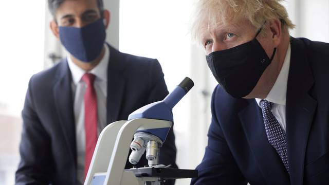 FILE PHOTO: Britain's PM Johnson and Chancellor of the Exchequer Sunak visit school in London