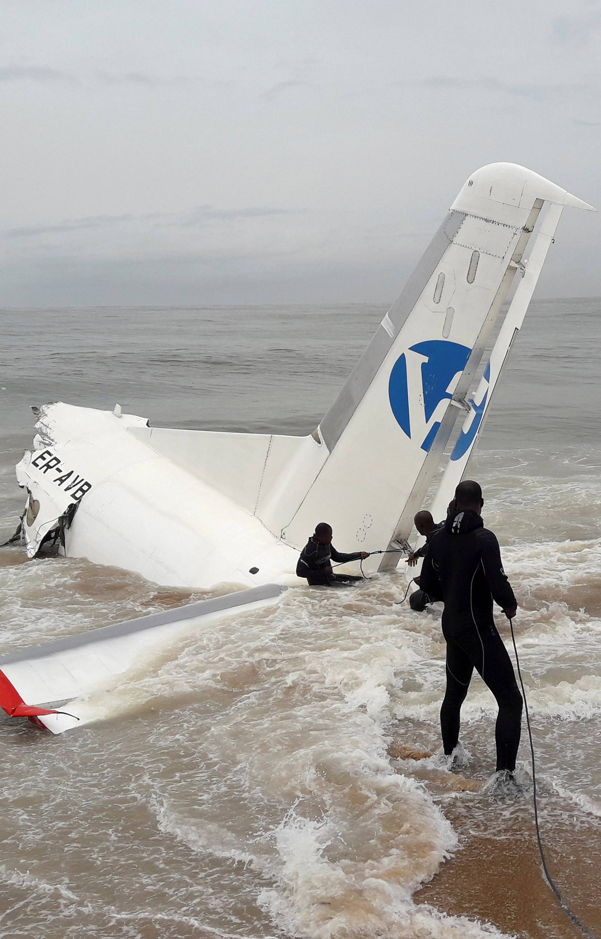 Rescuers pull the wreckage of a propeller-engine cargo plane after it crashed in the sea near the international airport in Ivory Coast's main city, Abidjan