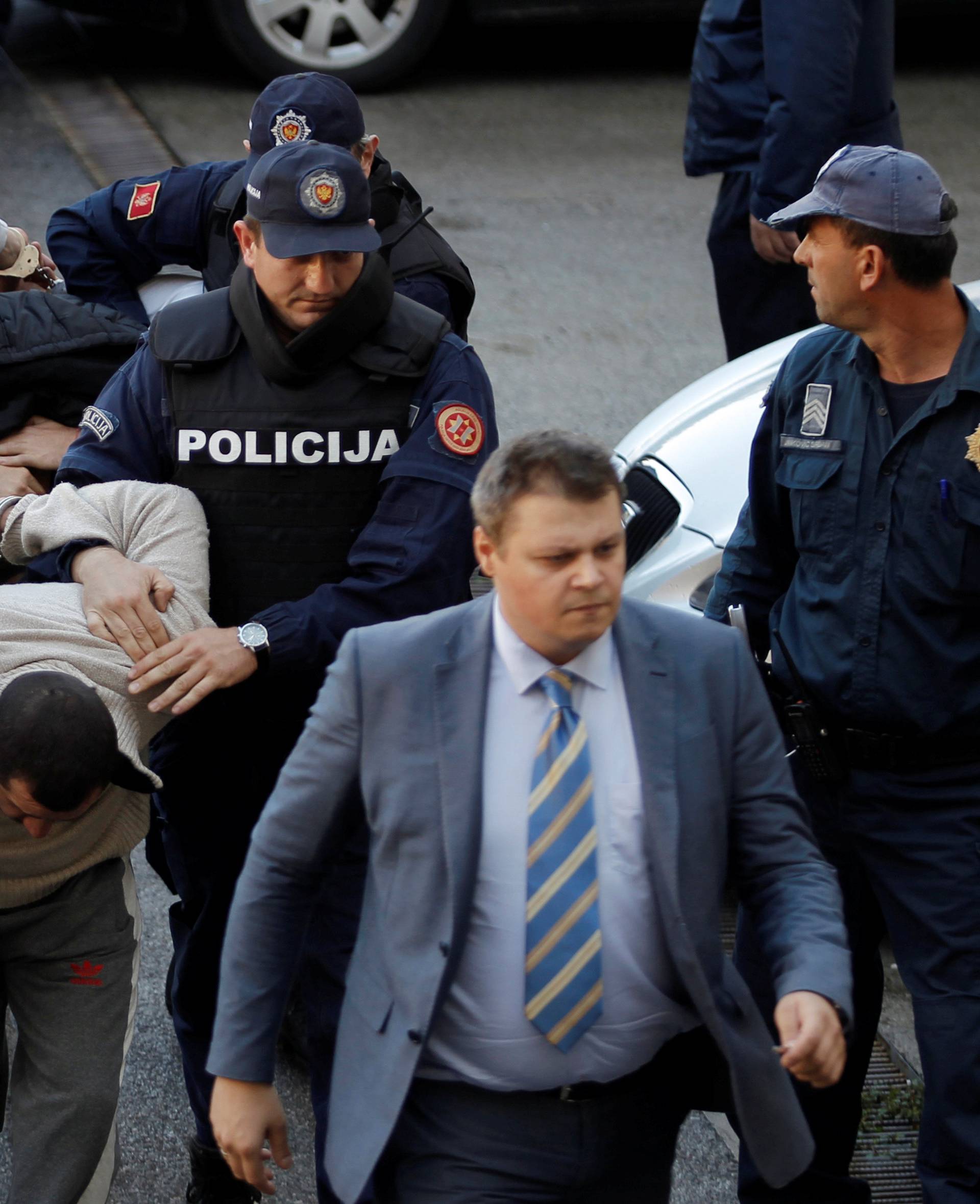 Montenegrin police escort men to a court session with the state attorney in Podgorica