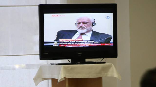 Bosnian Croat senior wartime official Praljak is seen during TV broadcast of the appeal trial in Mostar