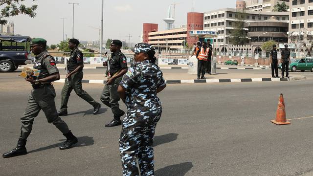 Police officers stand guard during a news conference by Bring Back Our Girls (BBOG) campaigners on the abducted Dapchi and Chibok girls in Abuja