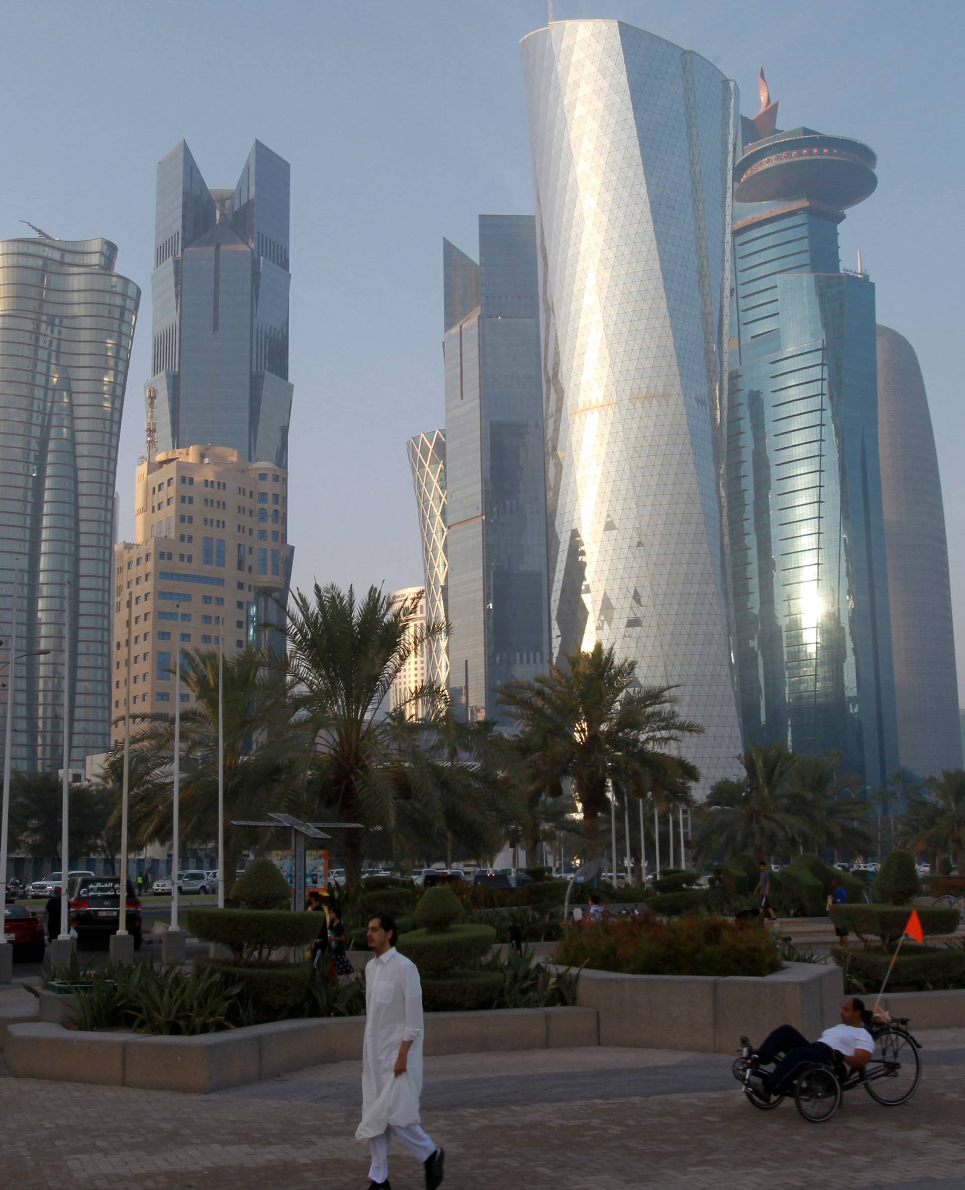 Man walks on the corniche in Doha