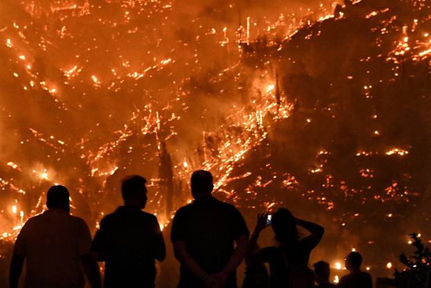 Wildfire burns next to the village of Kallithea, near Corinth