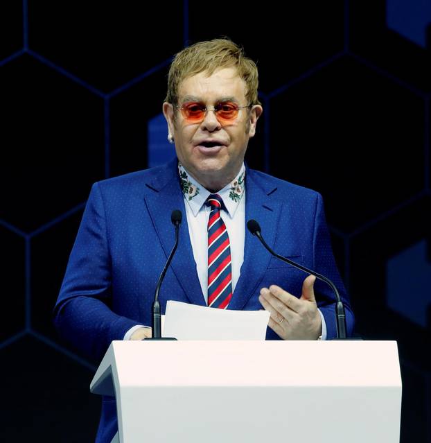 Singer Elton John speaks after receiving a Crystal Award from Hilde Schwab, Chairperson and Co-Founder, Schwab Foundation for Social Entrepreneurship, during the World Economic Forum (WEF) annual meeting in Davos