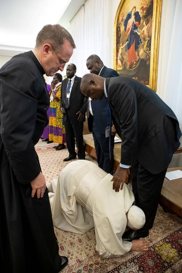 Pope Francis kneels to kiss feet of South Sudan leaders at the end of a two day Spiritual retreat with them at the Vatican