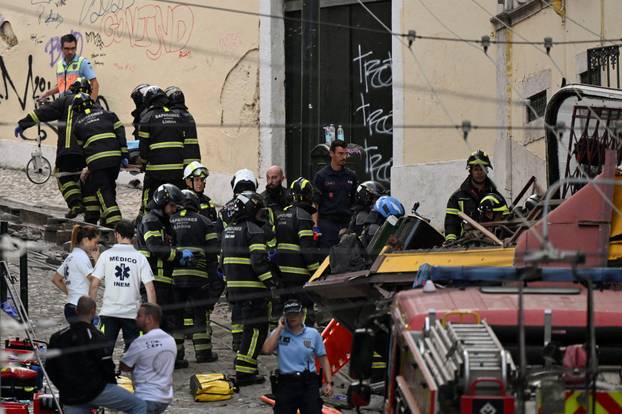 First responders work at the site of a funicular accident in Lisbon