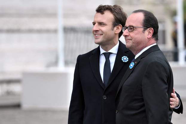 Outgoing French President Hollande and President-elect Macron attend a ceremony to mark the end of World War II at the Tomb of the Unknown Soldier at the Arc de Triomphe in Paris