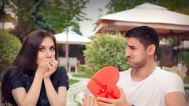 Happy Girl Receiving Heart Shaped Gift from her Boyfriend