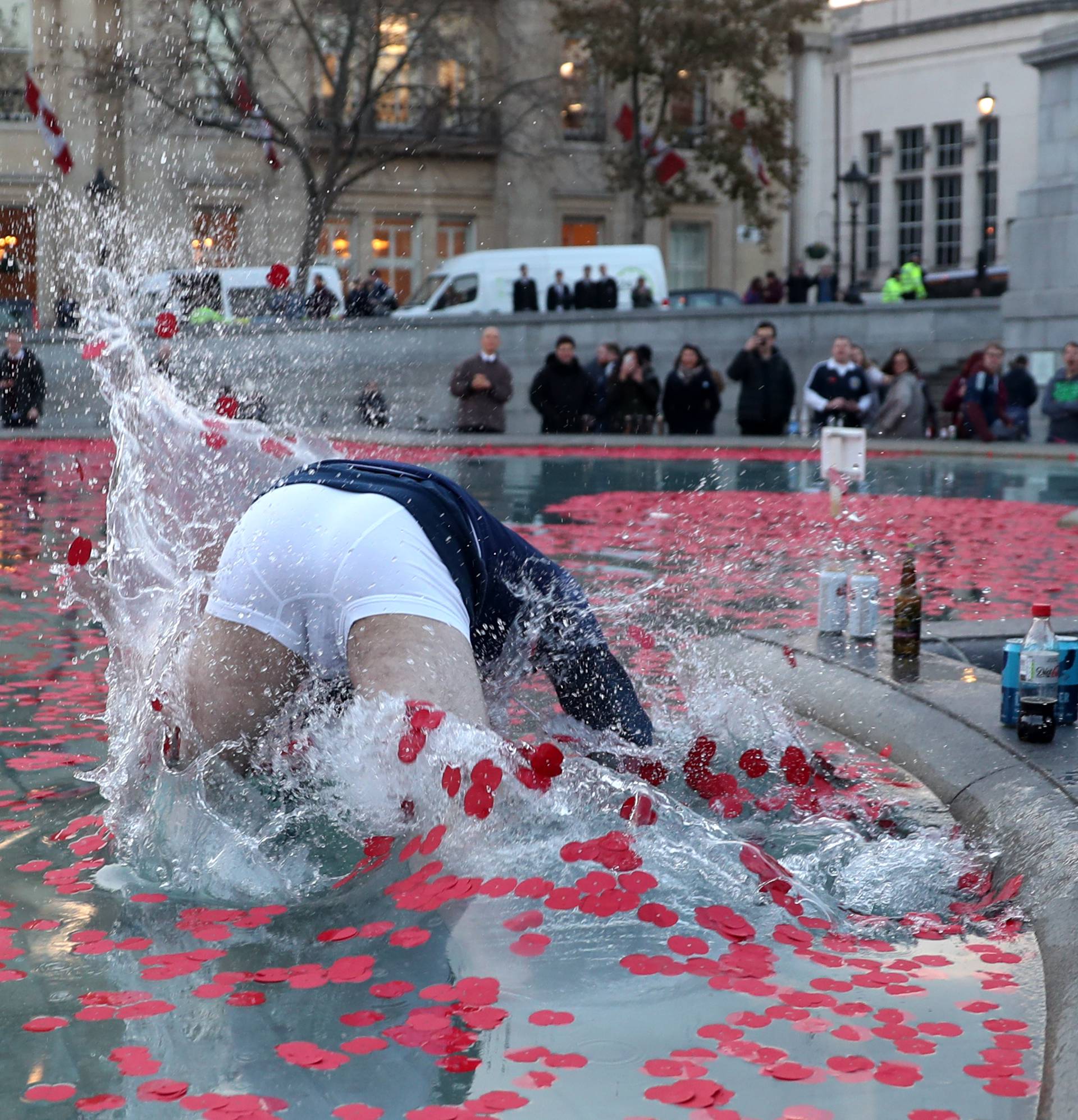 A Scotland fan in the water fountain in Trafalgar Square