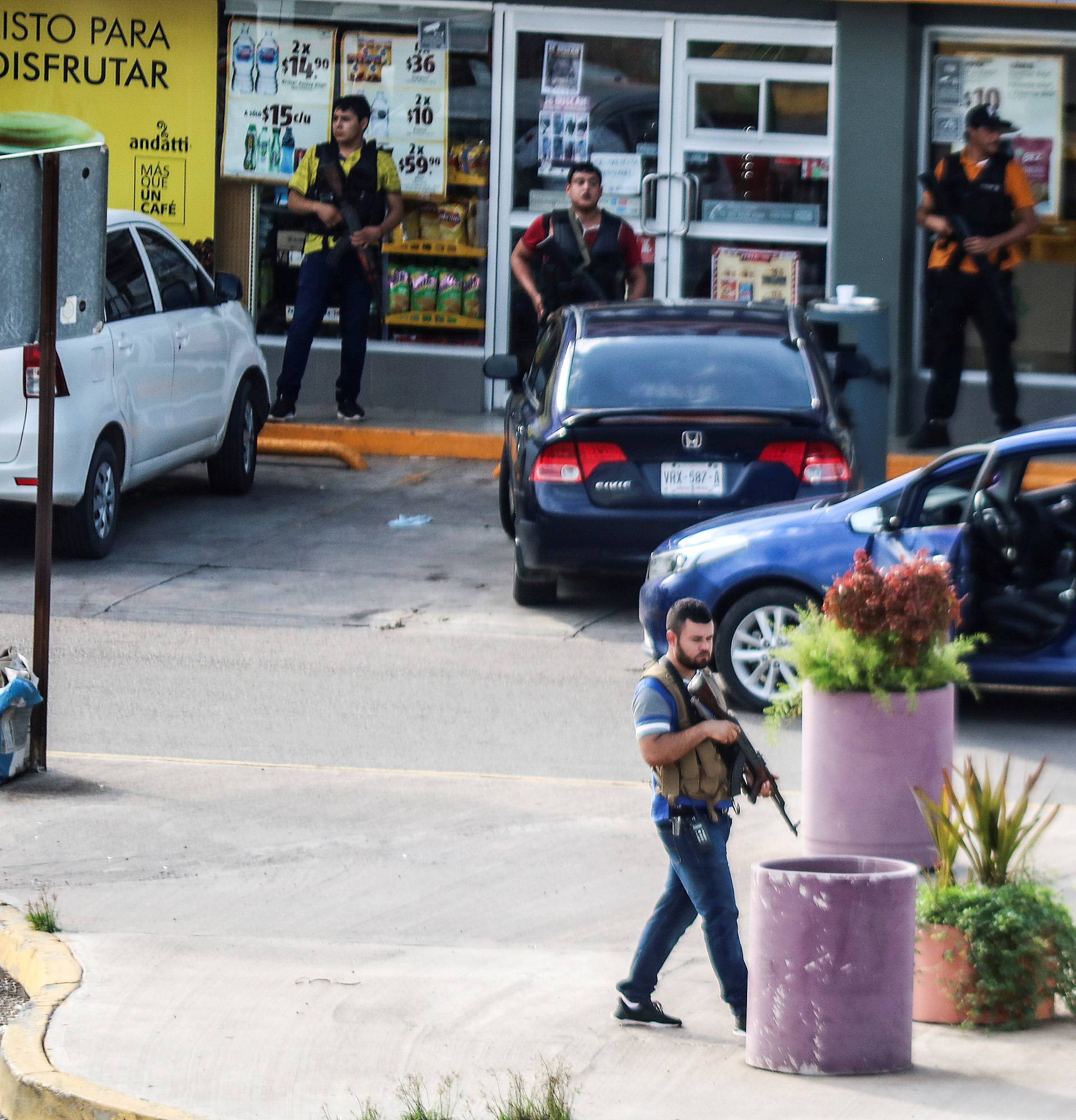 Cartel gunmen are seen outside during clashes with federal forces following the detention of Ovidio Guzman, son of drug kingpin Joaquin "El Chapo" Guzman, in Culiacan