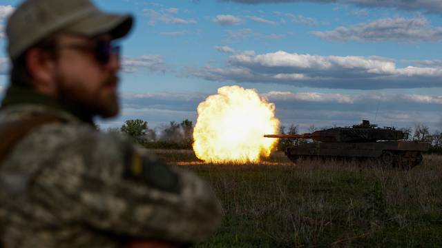Ukrainian servicemen fire a Leopadr 2A6 tank during a military exercise in Donetsk region