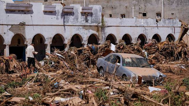 A view shows a damaged car, following a powerful storm and heavy rainfall hitting the country, in Derna