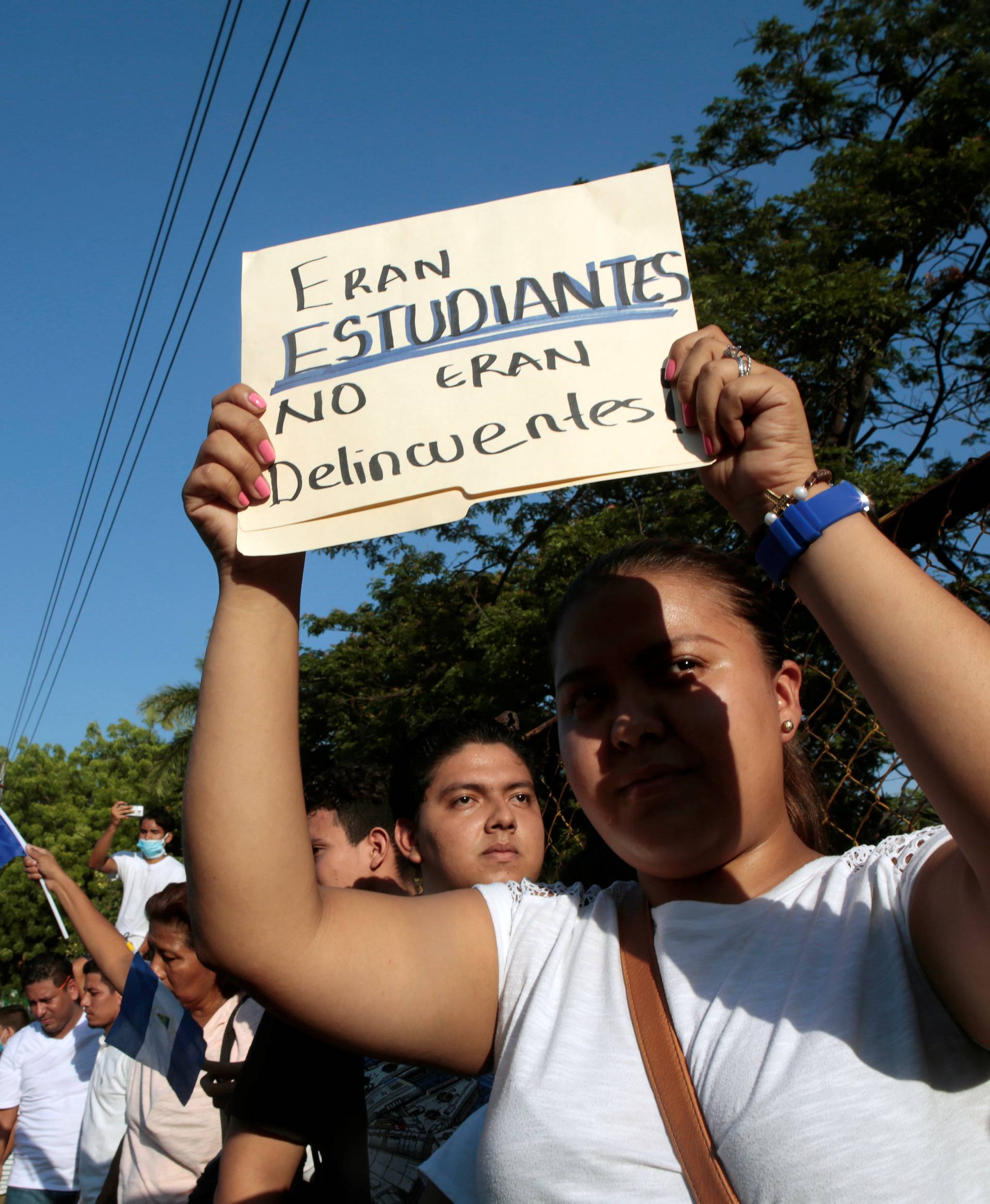 A demonstrator holds up a sign during a protest against police violence and the government of Nicaraguan President Daniel Ortega in Managua