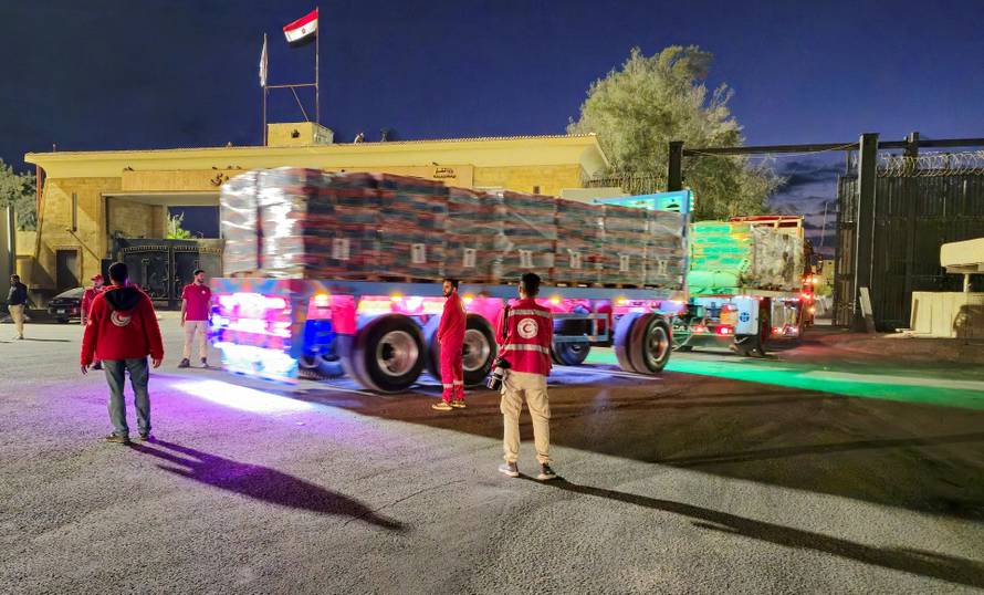 FILE PHOTO: Trucks carrying aid bound for Gaza cross the border crossing between Egypt and the Gaza Strip