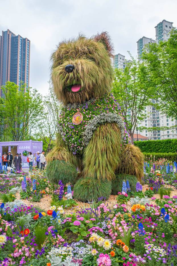 SHANGHAI, CHINA - APRIL 19: A 5.2-meter-tall puppy made of flowers and greenery steals the spotlight at the ongoing 2026