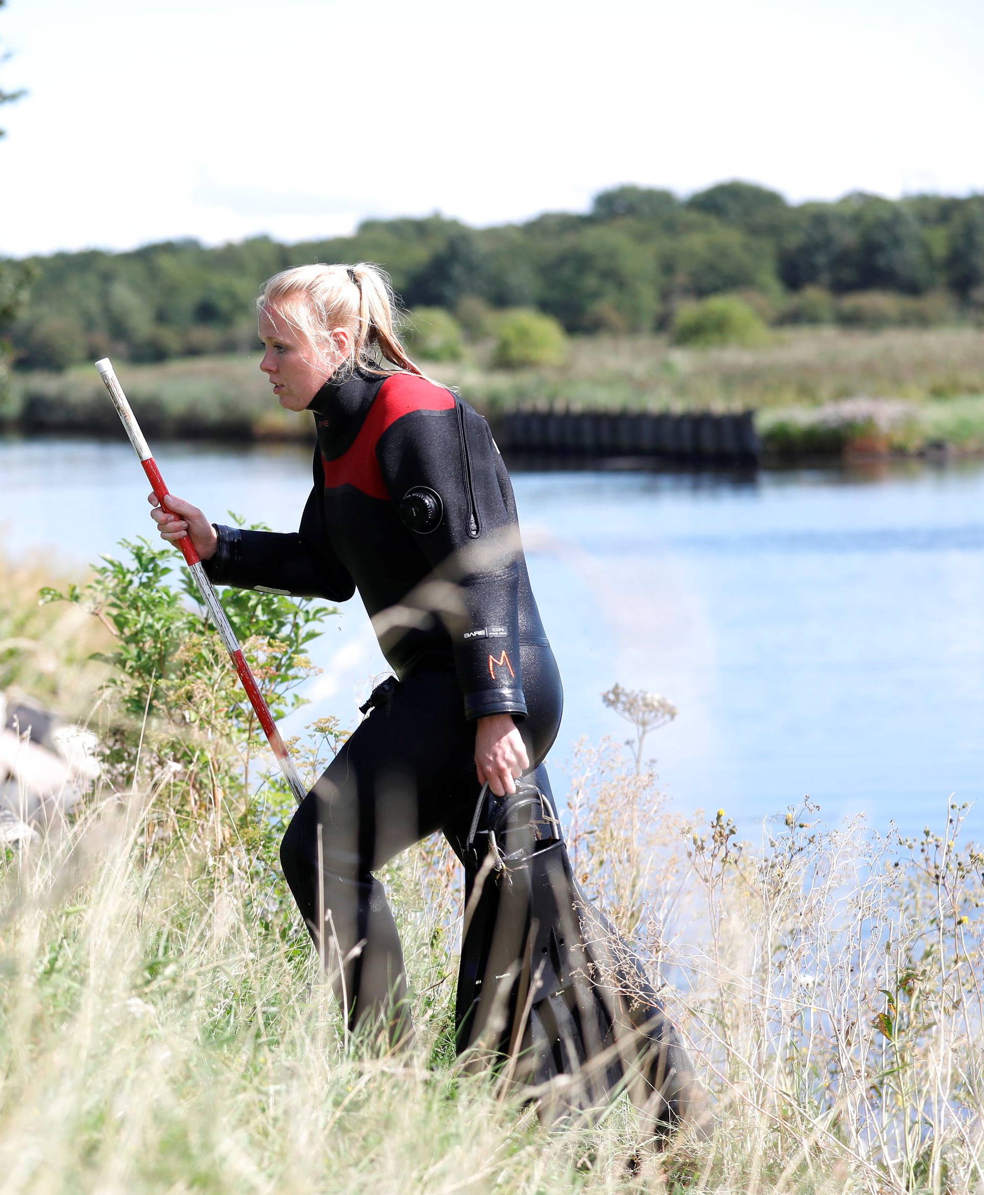 Members of the Danish Emergency Management Agency (DEMA) (Danish: Beredskabsstyrelsen) assist police at Kalvebod Faelled in search of missing body parts of journalist Kim Wall close to the site where her torso was found, in Copenhagen