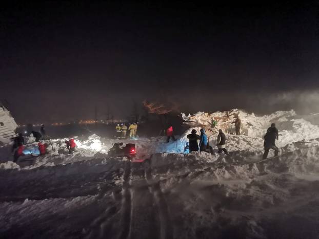 Rescuers take part in a search operation after an avalanche hit a ski resort in Norilsk
