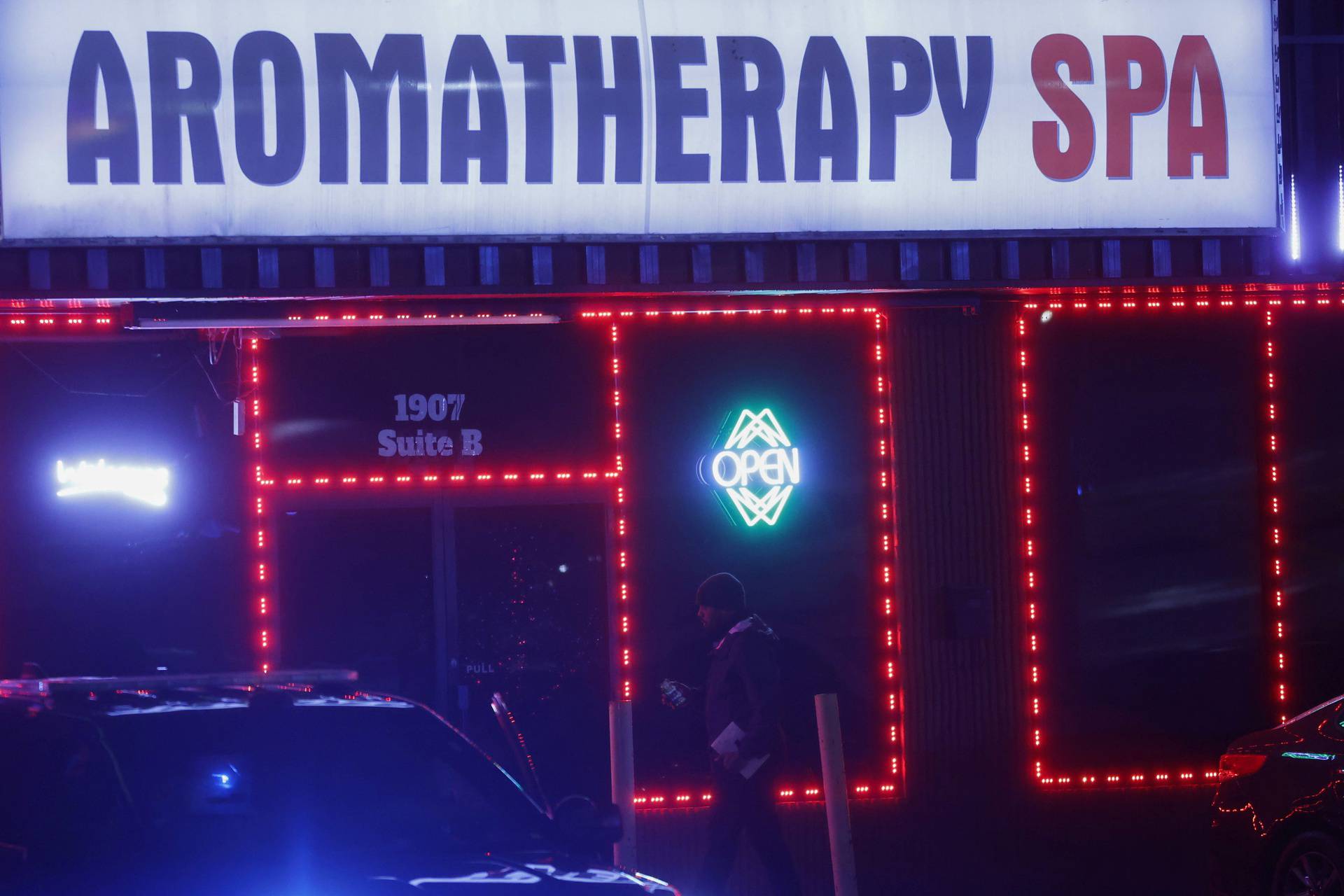 People working at the crime scene enter Aromatherapy Spa after deadly shootings at spas in Atlanta