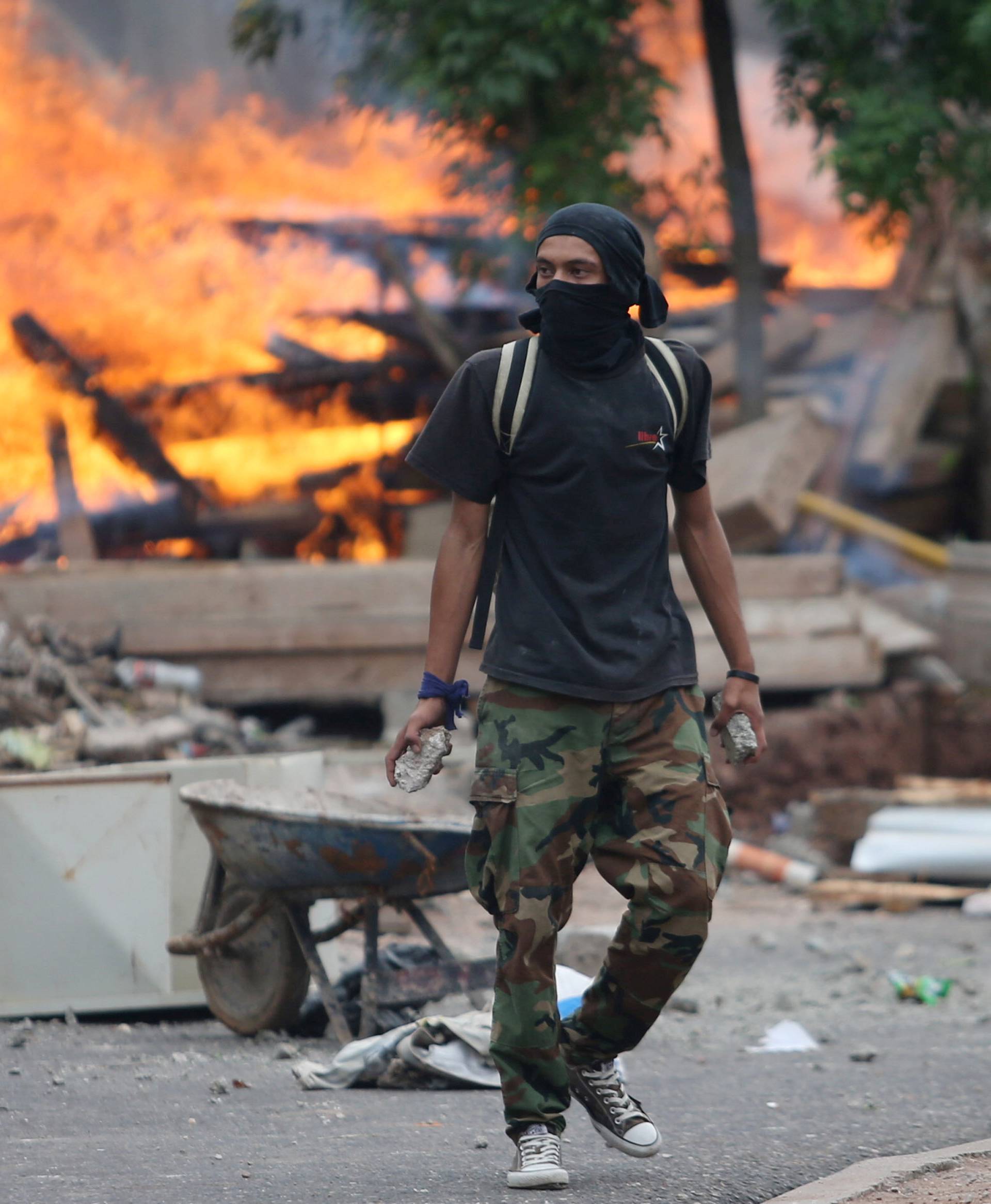 Supporters of presidential candidate Nasralla clash with riot police as they wait for official presidential election results in Tegucigalpa