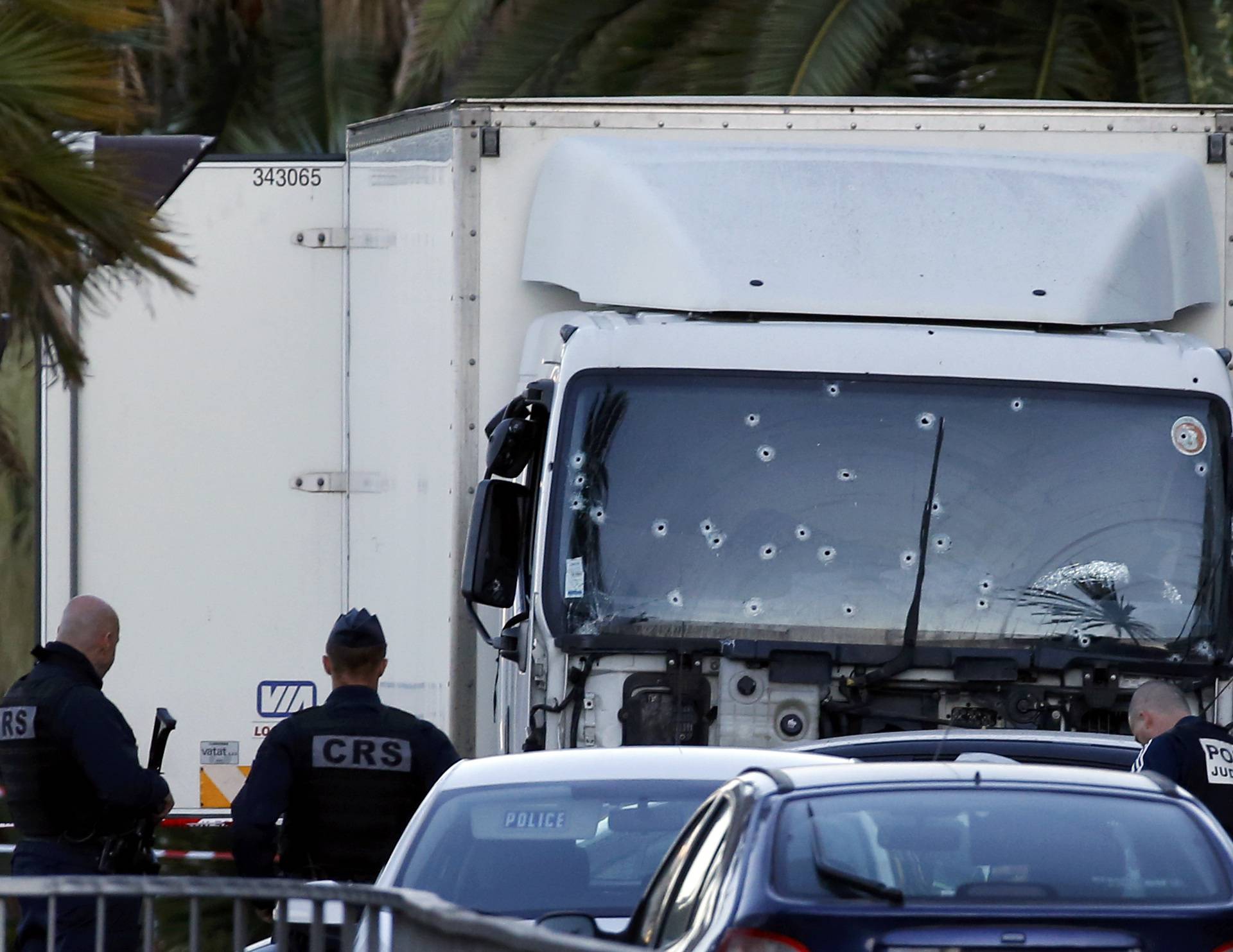 French CRS and judicial police work near the heavy truck that ran into a crowd at high speed celebrating the Bastille Day July 14 national holiday on the Promenade des Anglais killing 80 people in Nice