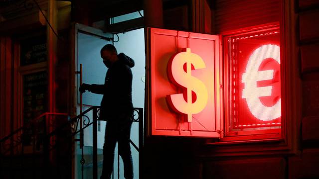 FILE PHOTO: A man walks out of a currency exchange office in Saint Petersburg