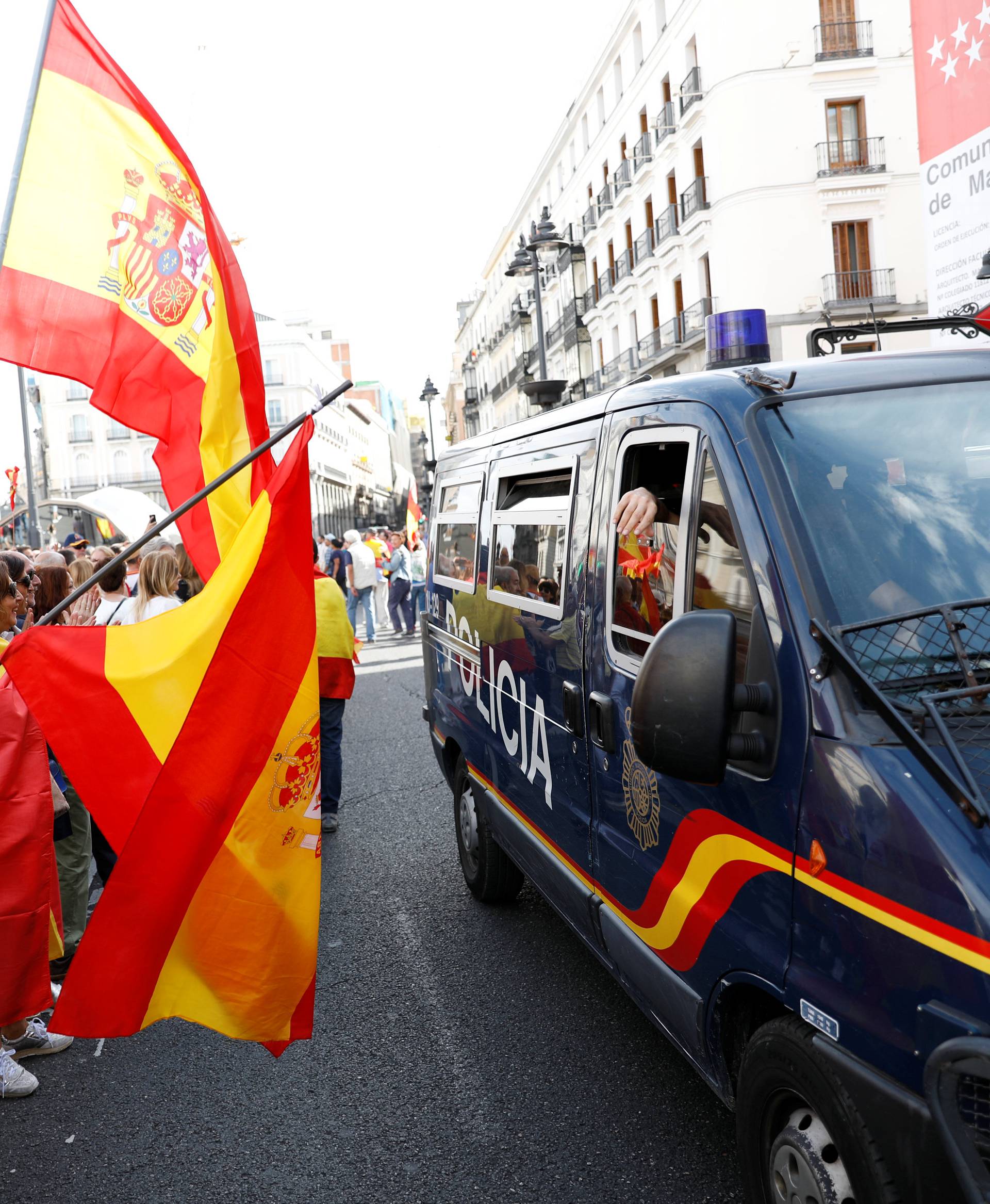 Demonstrators wave Spanish flags and support police during a demonstration in favor of a unified Spain on the day of a banned independence referendum in Catalonia, in Madrid