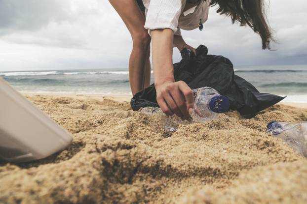 Volunteer,Woman,Collecting,Trash,On,The,Beach.,Trash-free,Seas,Concept.