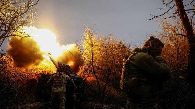 Ukrainian serviceman fire a D-30 howitzer towards Russian troops at a position in a front line in Kherson region