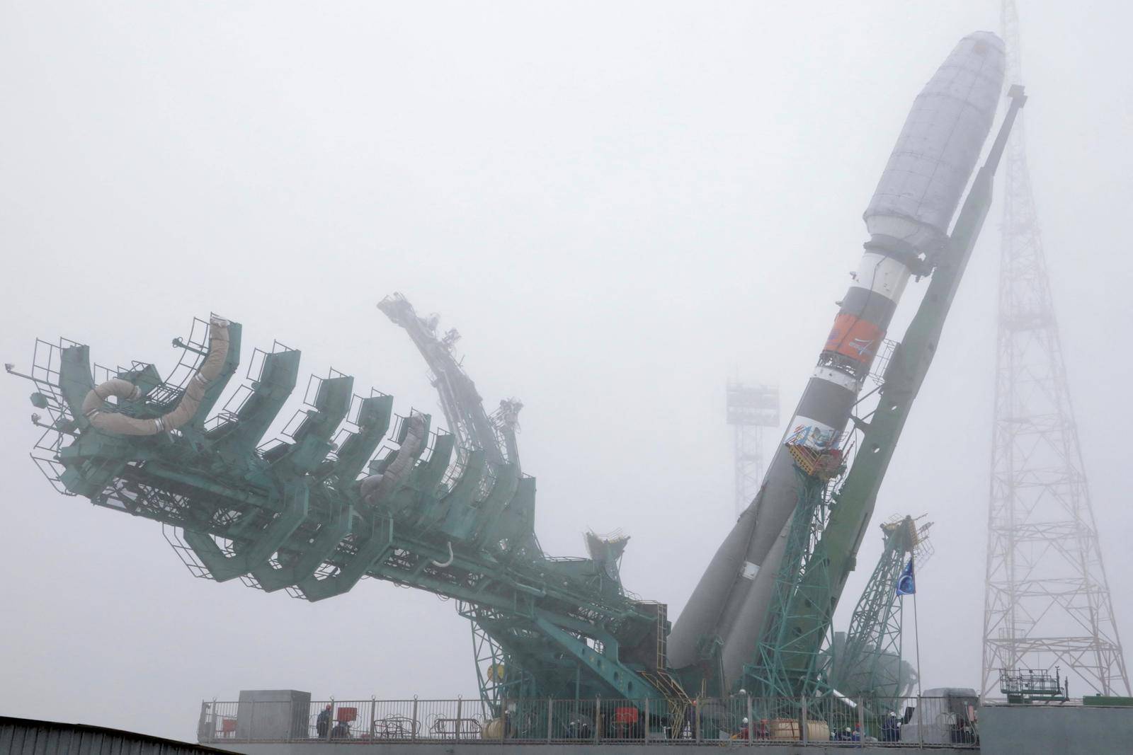 A Soyuz rocket booster with satellites of British firm OneWeb is transported to a launchpad at the Baikonur Cosmodrome