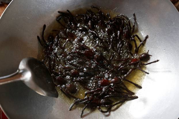 Tarantulas are fried in a pan in Kampong Cham province in Cambodia