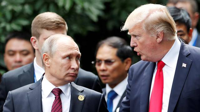 FILE PHOTO: U.S. President Donald Trump and Russia's President Vladimir Putin talk during the family photo session at the APEC Summit in Danang, Vietnam