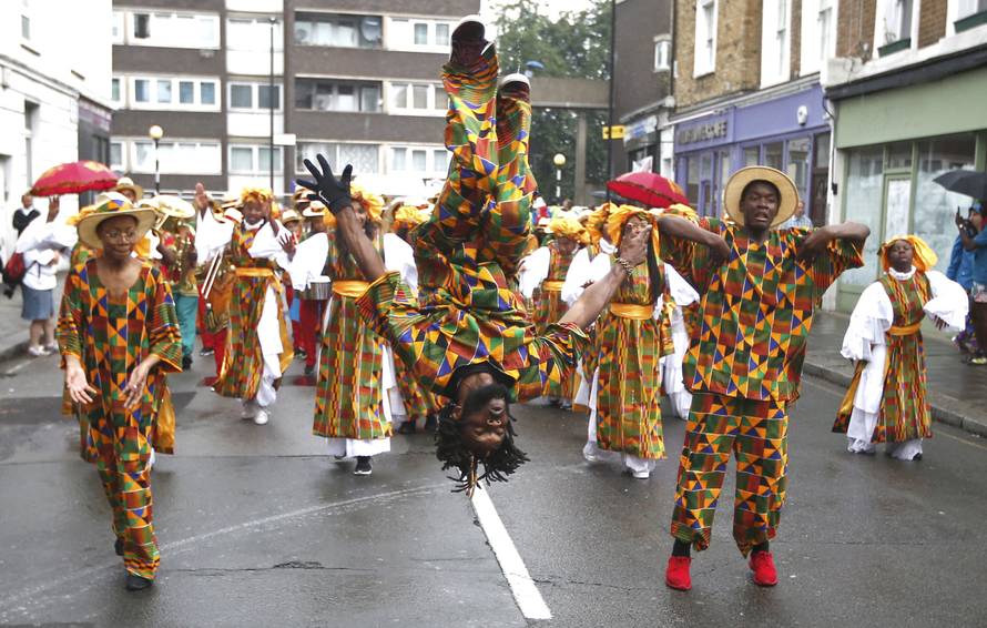 Performers participate in the children's day parade at the Notting Hill Carnival in London