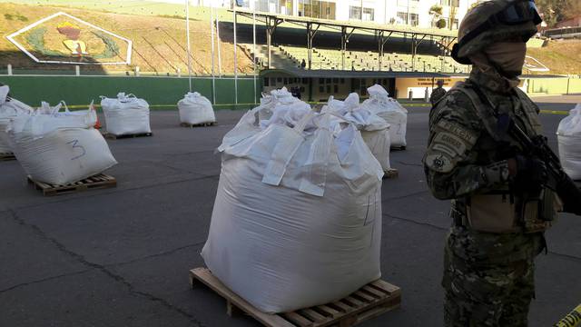 A member of Bolivian Special Force of Fight against traffic of Narcotics FELCN stands next to bags of Cocaine at the police headquarter in La Paz