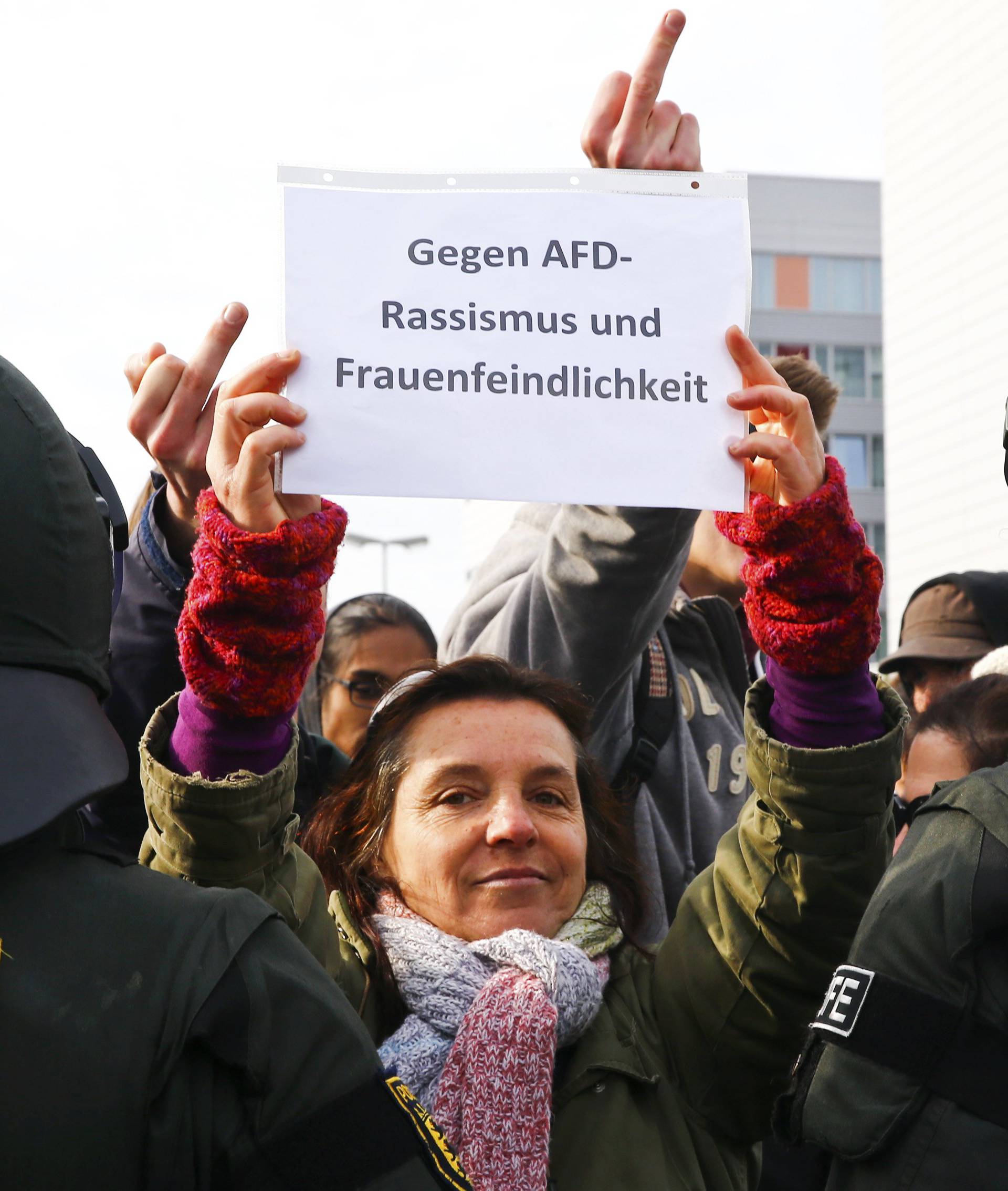 Anti-AfD protestors hold a banner reading 'Against AfD-racism and misogyny' during the AfD party congress in Stuttgart