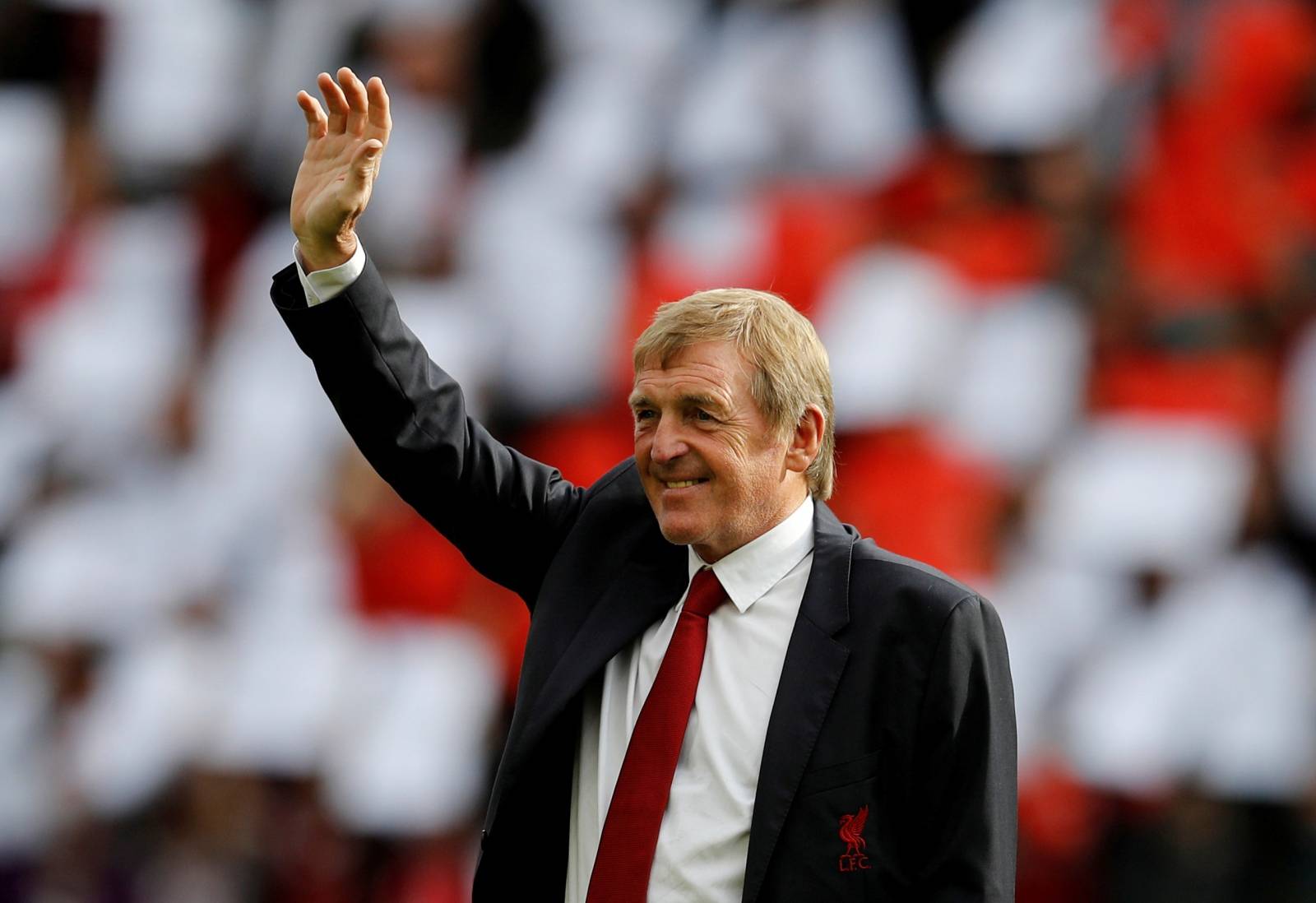 FILE PHOTO: Kenny Dalglish waves to fans before Liverpool's match with Manchester United