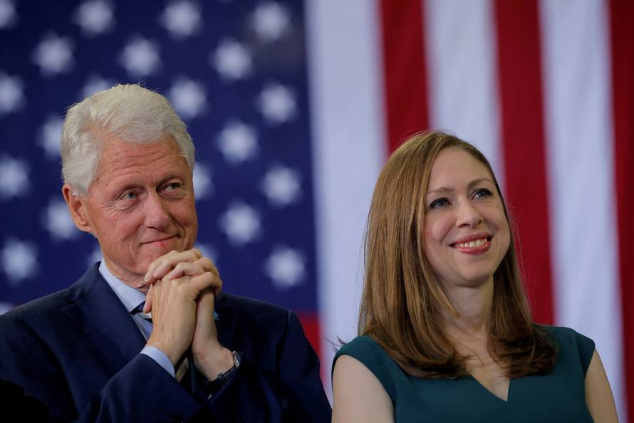 Former U.S. President Bill Clinton and Chelsea Clinton listen as U.S. Democratic presidential nominee Hillary Clinton speaks at a campaign rally in Raleigh