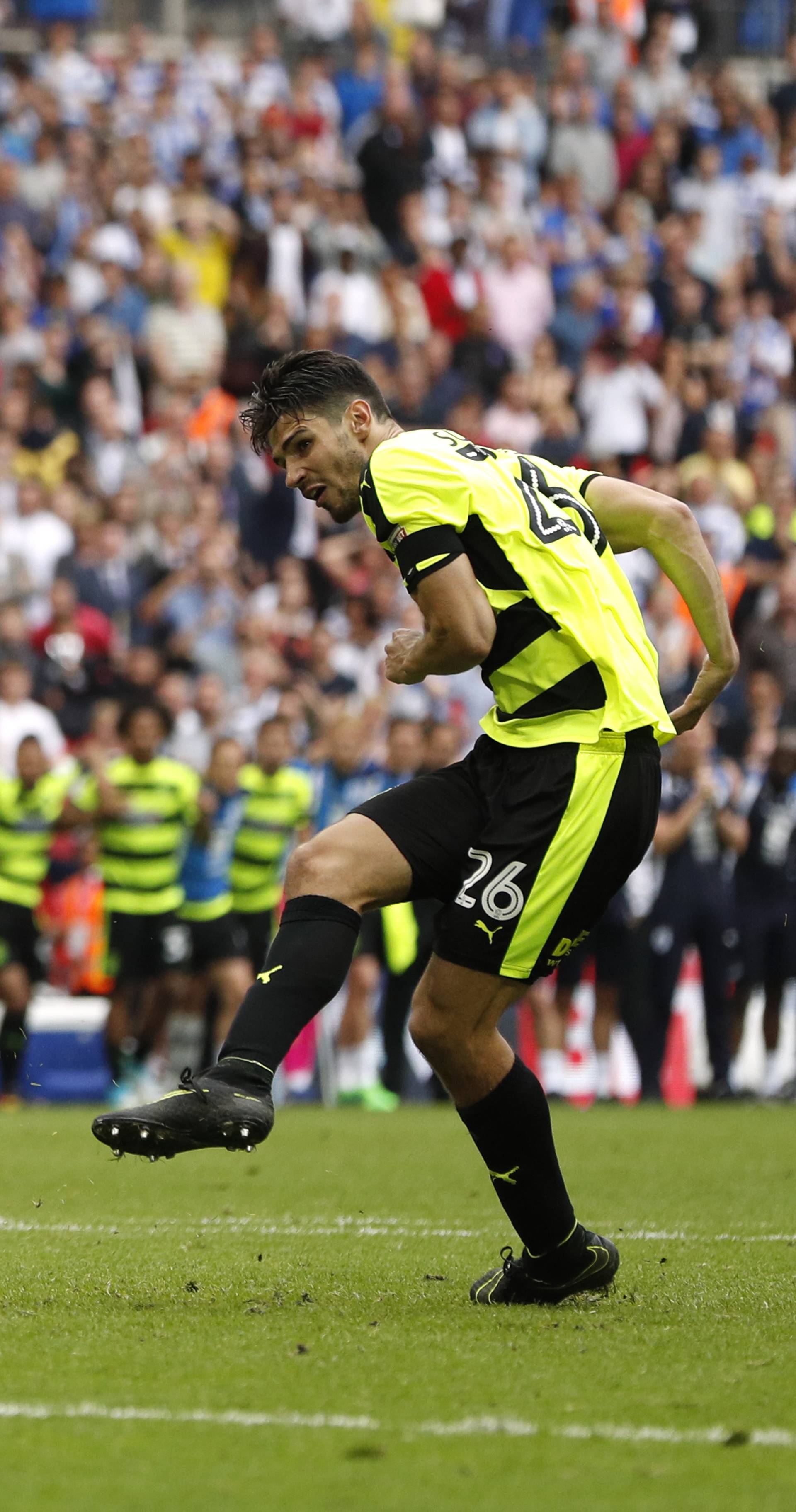 Huddersfield Town's Christopher Schindler scores a penalty to win the penalty shootout and get promoted to the Premier League