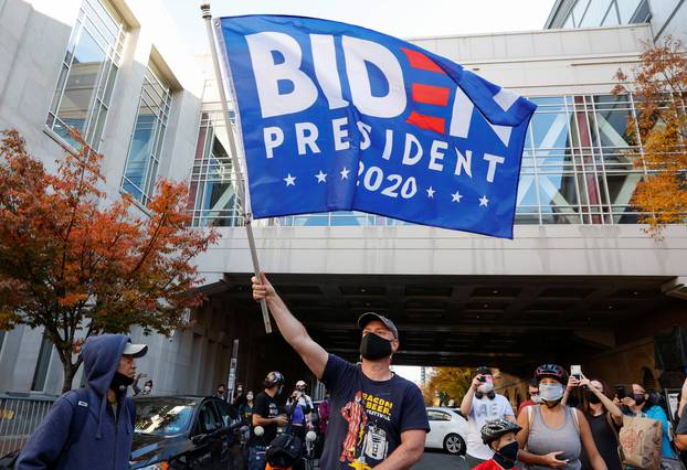 People react as media announce that Democratic U.S. presidential nominee Joe Biden has won the 2020 U.S. presidential election, in, Philadelphia
